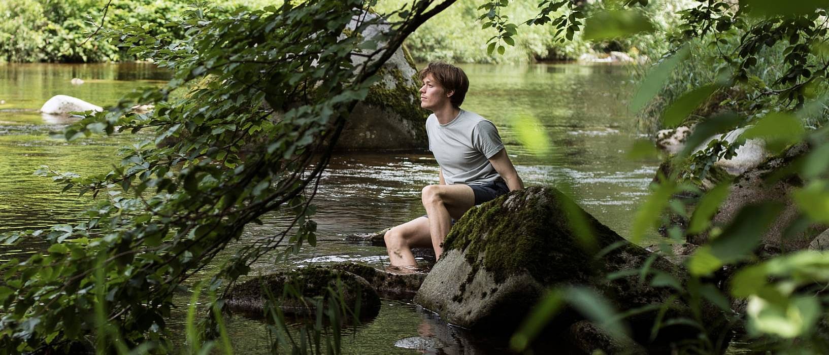 person sitting at river