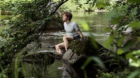 person sitting at river